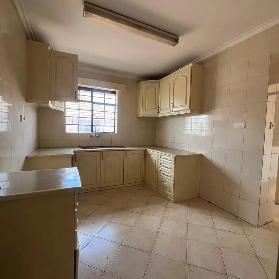 Spacious kitchen with wooden cabinets and tiled flooring
