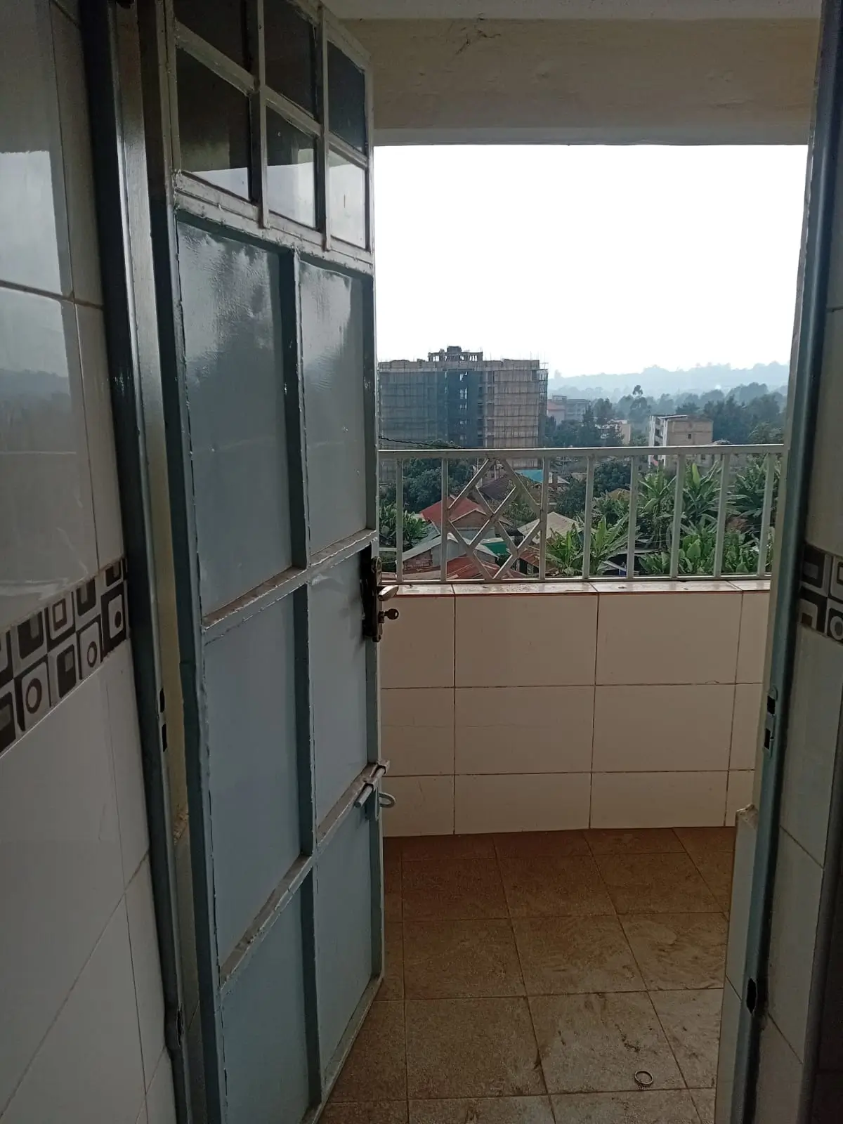 Balcony with city skyline and green landscape views
