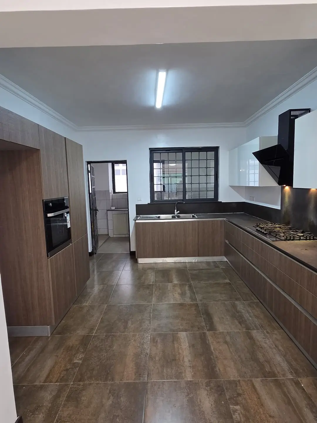 Modern kitchen with wood cabinetry and stainless steel appliances