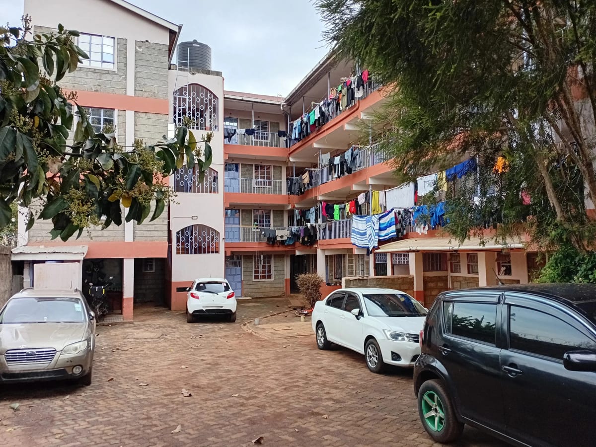 Multi-story residential building with shared compound parking area