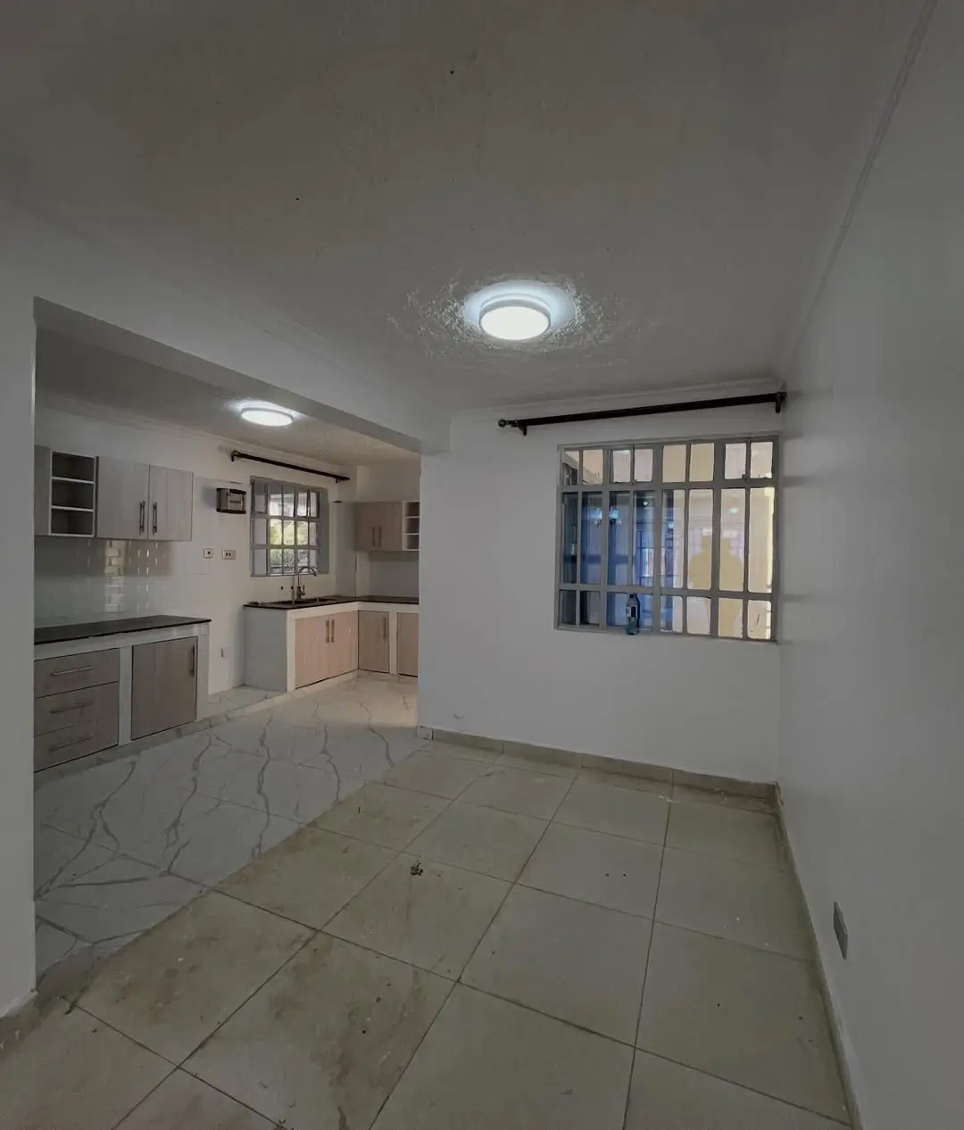 Open-plan kitchen and dining area with tiled flooring