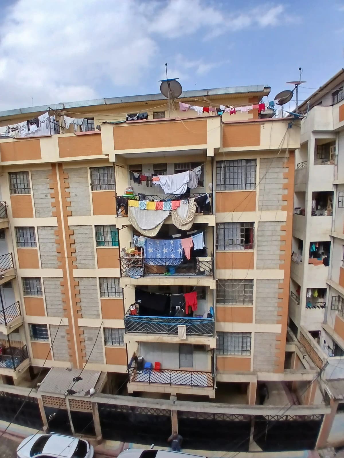 Multi-story residential building facade with balconies and clotheslines