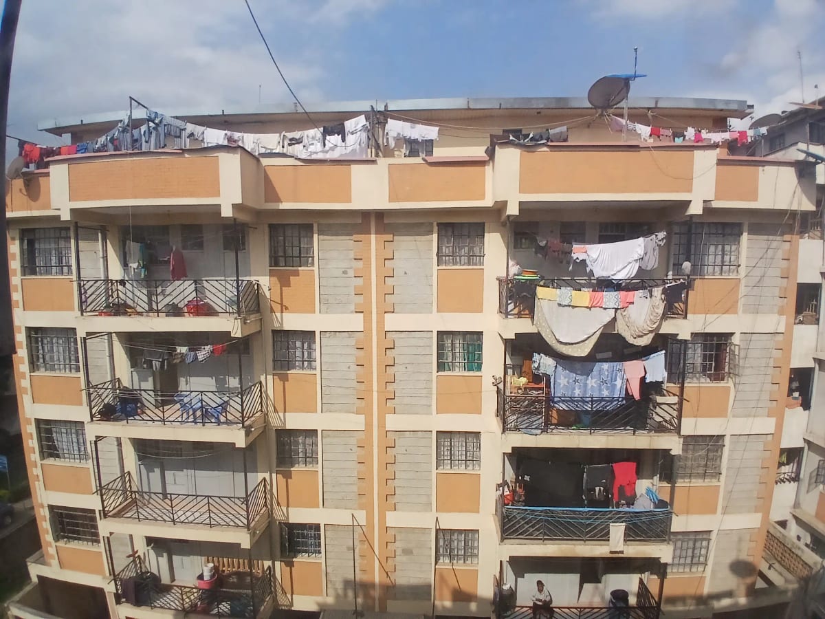 Multi-story residential building facade with balconies and clotheslines