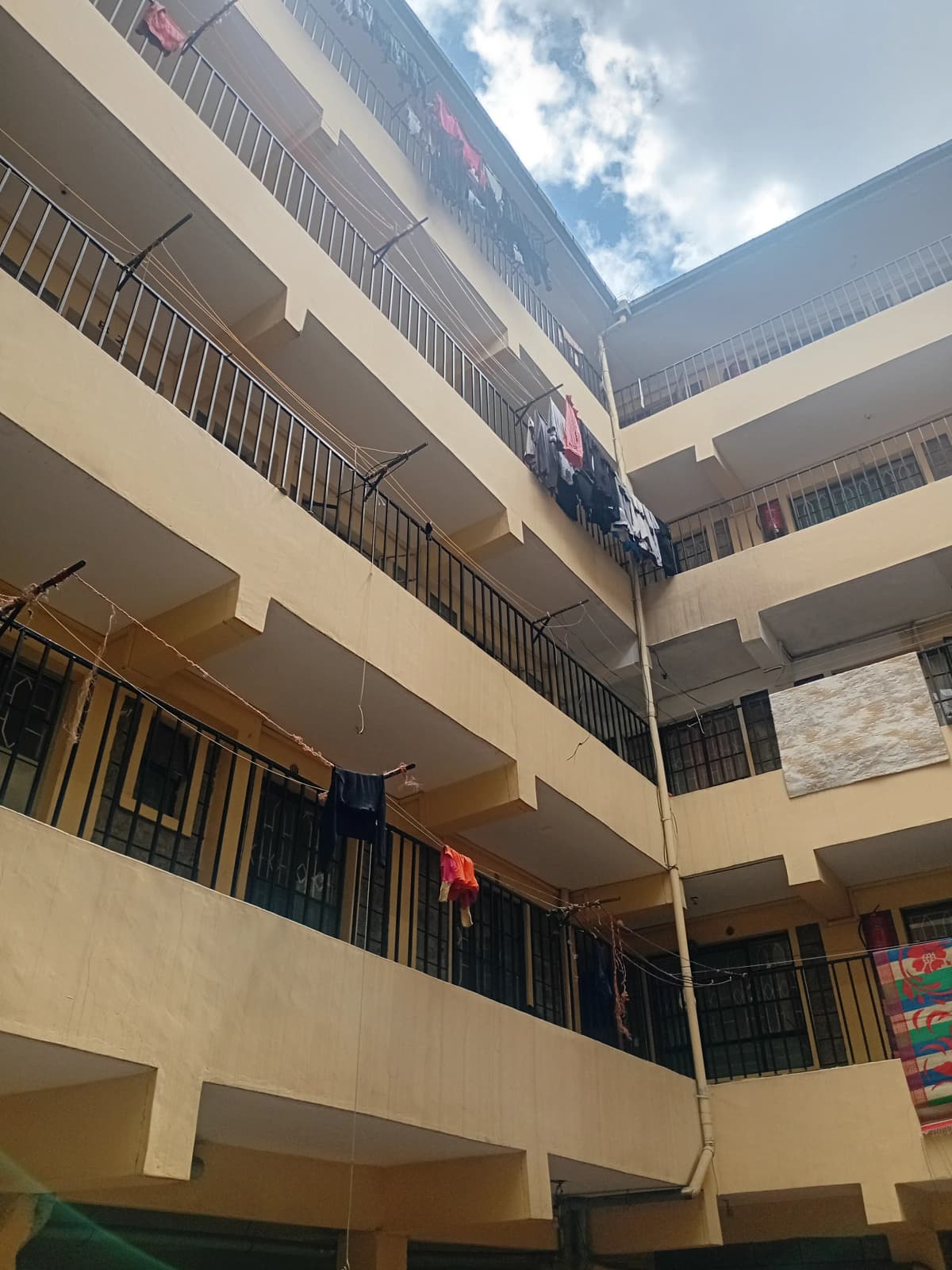 Multi-story residential building facade with balconies and courtyard