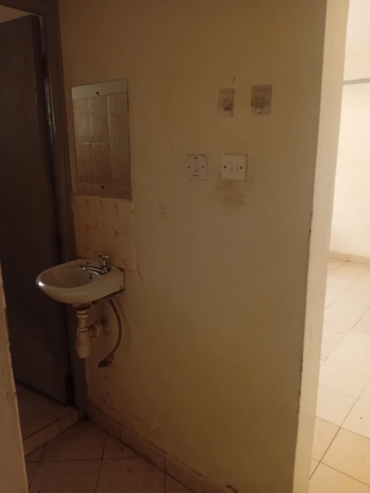 Compact bathroom with wall-mounted sink and minimal fixtures