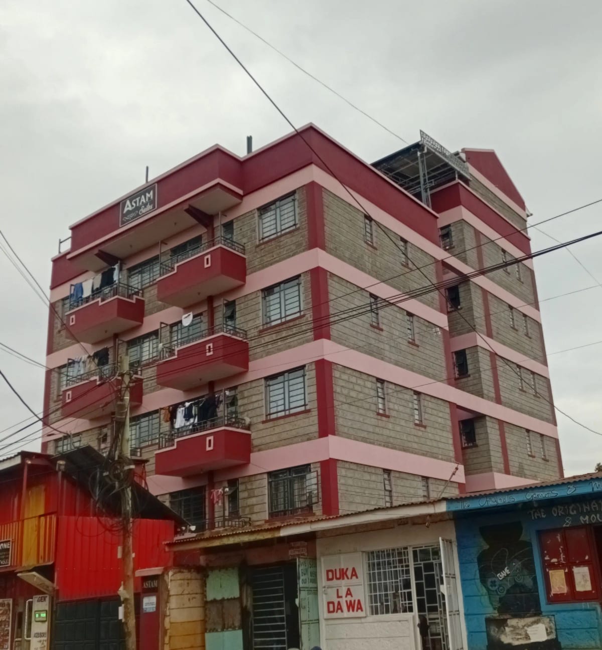 Red and cream multi-story apartment building with balconies