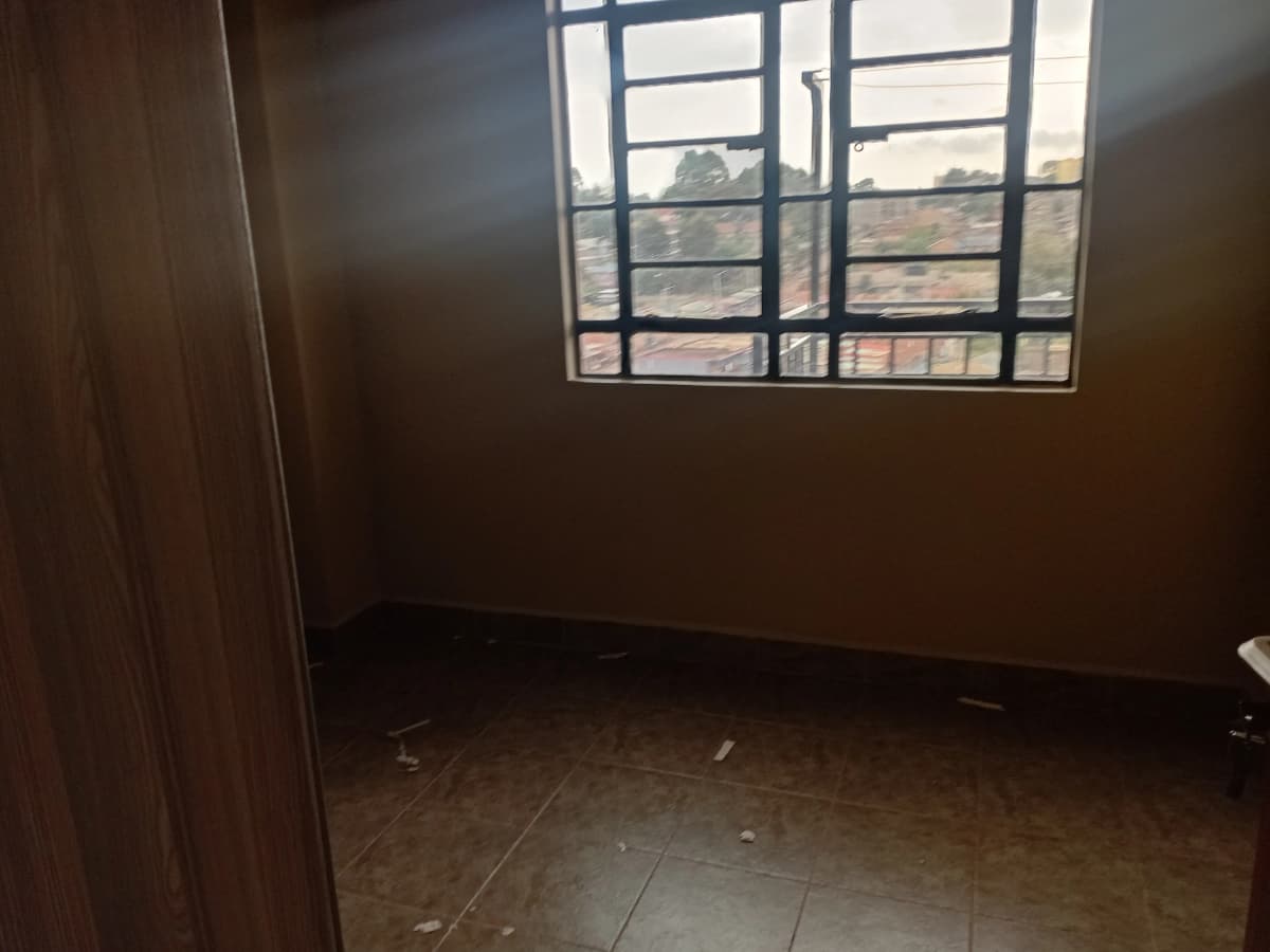 Empty bedroom with window overlooking residential area