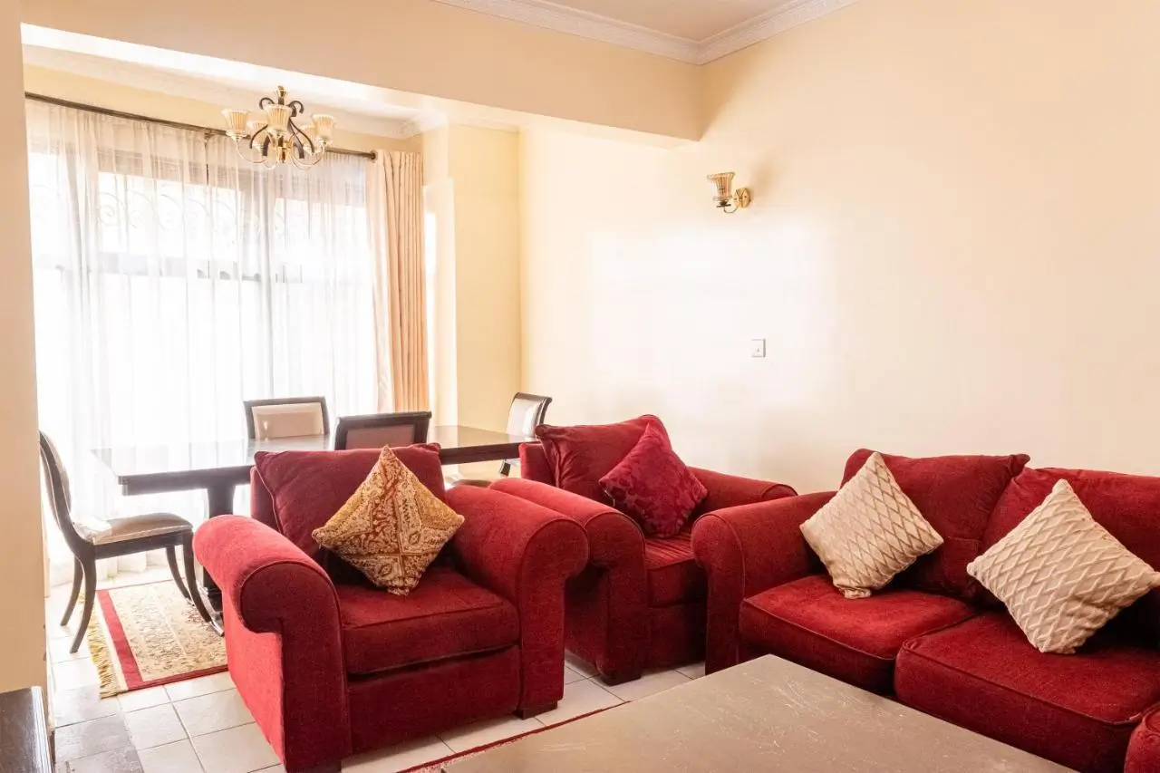 Spacious living room with burgundy sectional sofa and floor-to-ceiling windows
