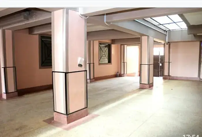 Spacious lobby with polished floors and structural columns