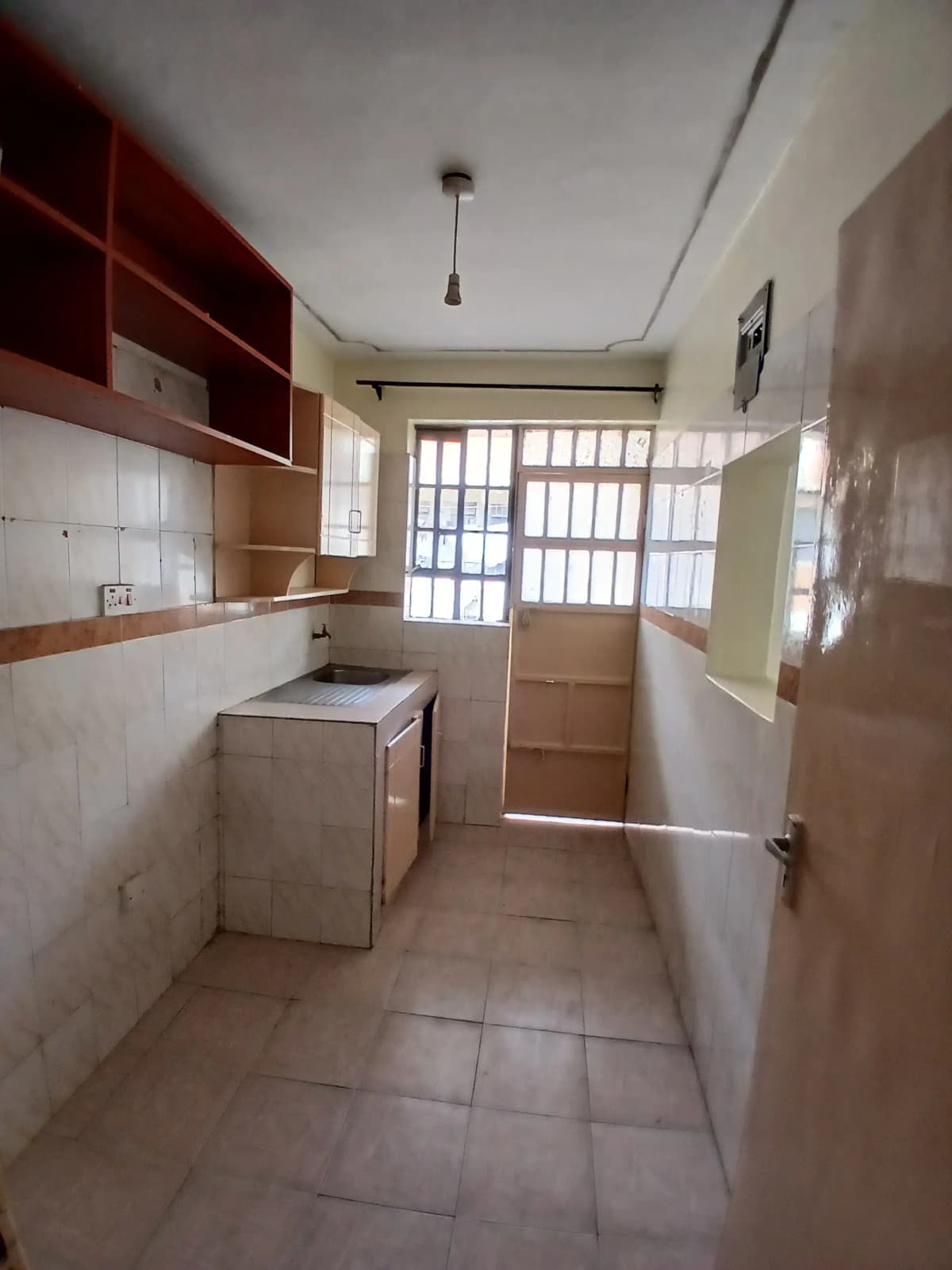 Compact kitchen with washing machine and natural light entry