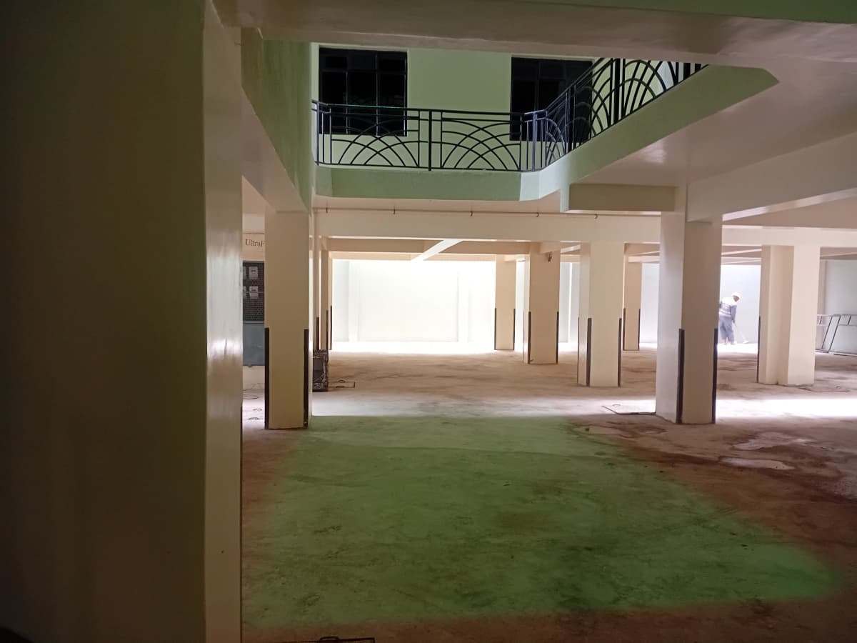 Multi-level building lobby with columns and mezzanine balcony