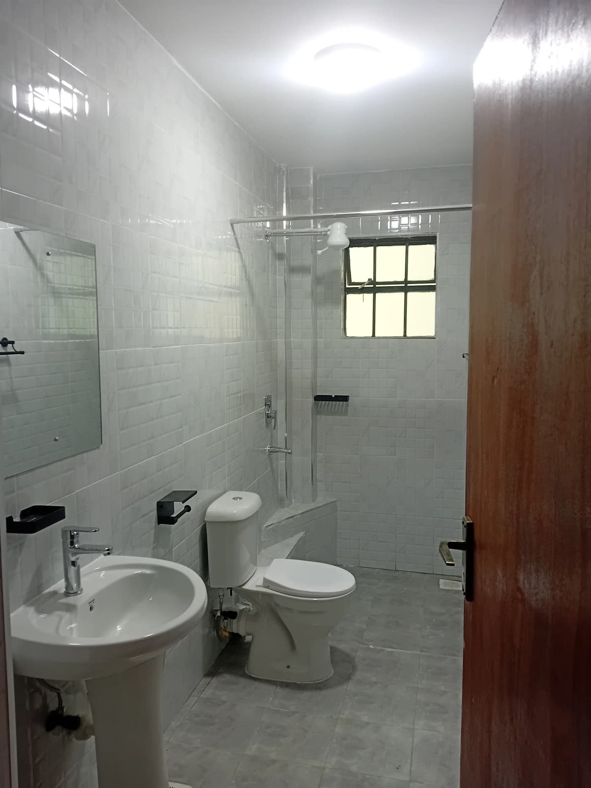 Clean bathroom with multiple white sinks and fixtures