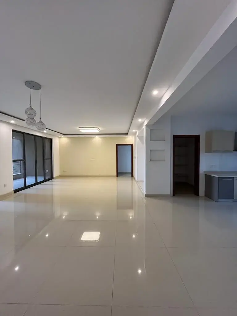 Spacious open-plan living area with polished marble flooring
