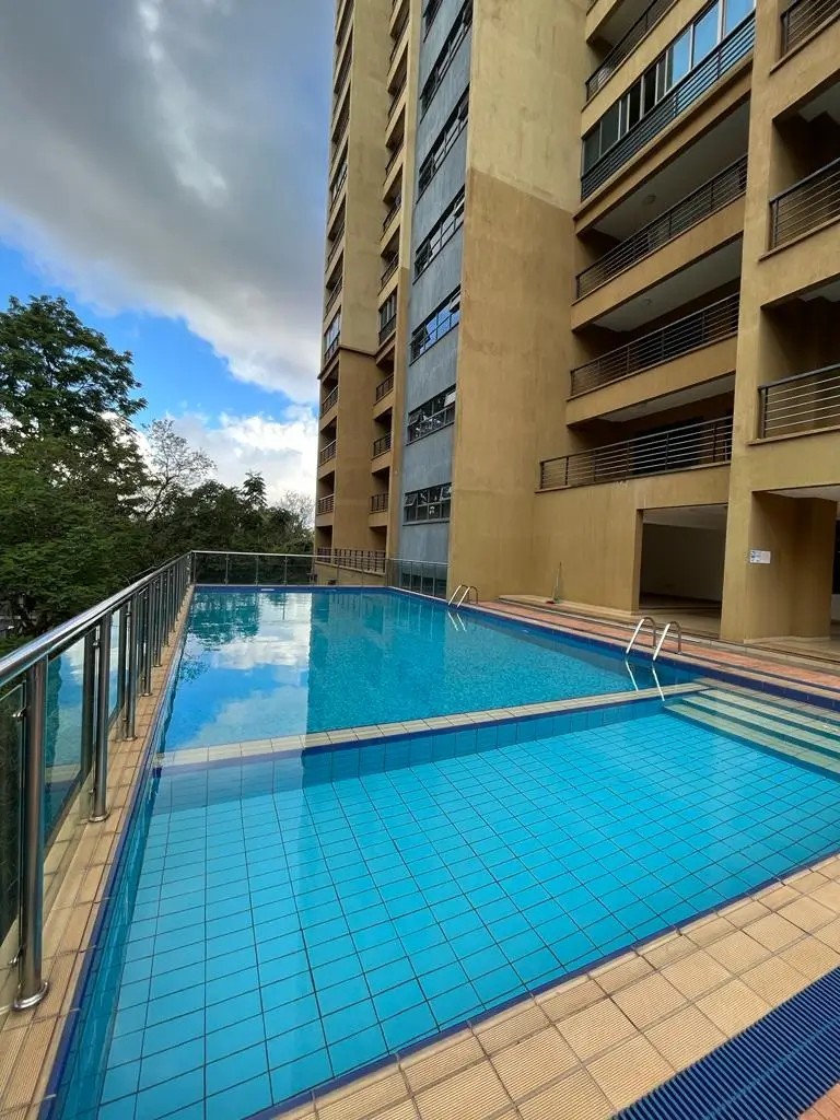 Rectangular swimming pool with lap lanes and building backdrop