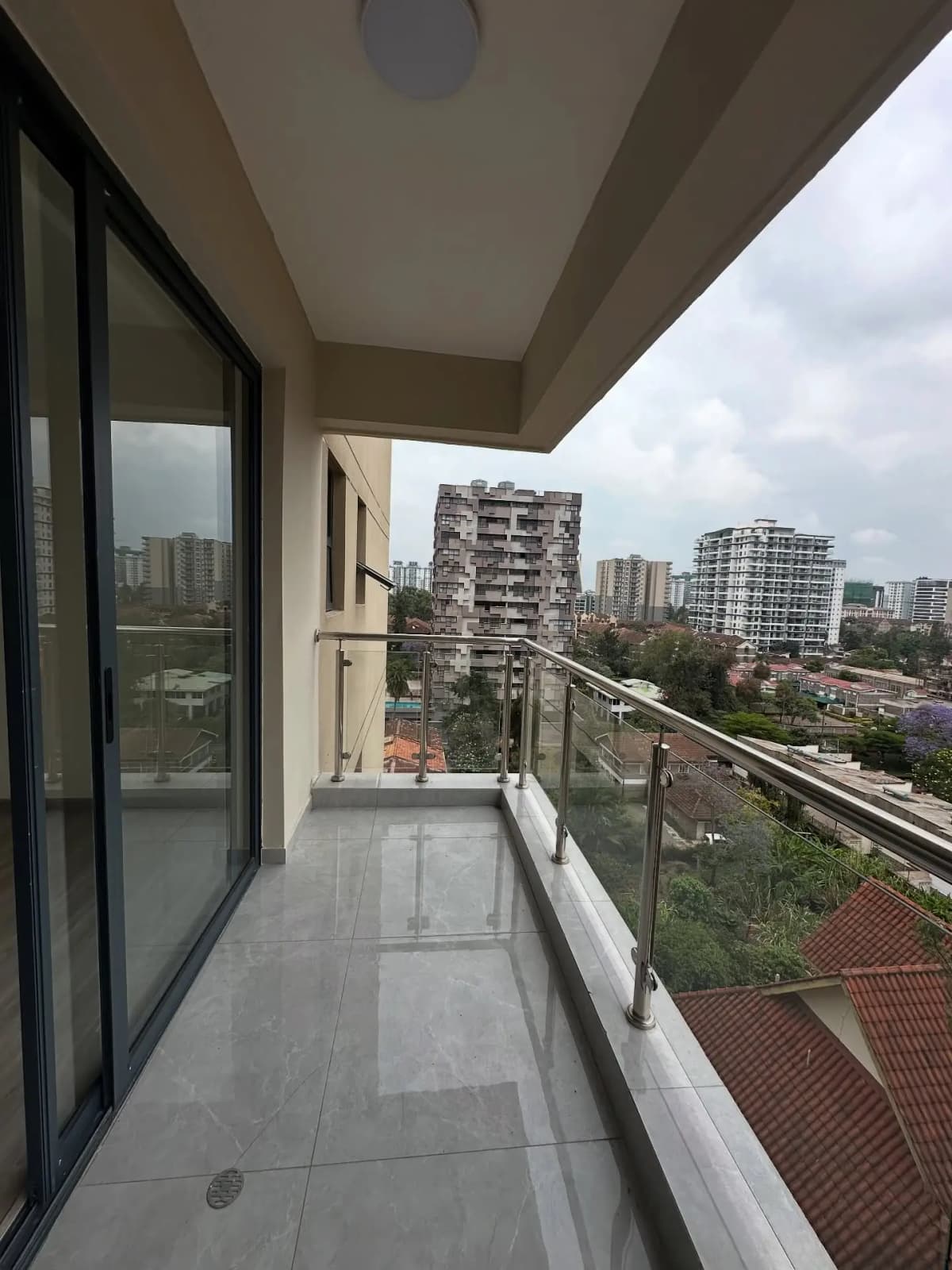 Spacious balcony with city skyline and residential towers views