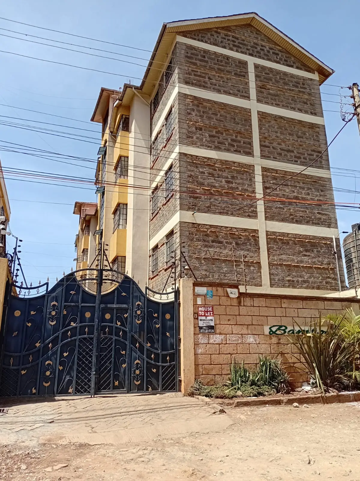 Multi-story residential building with decorative gate entrance
