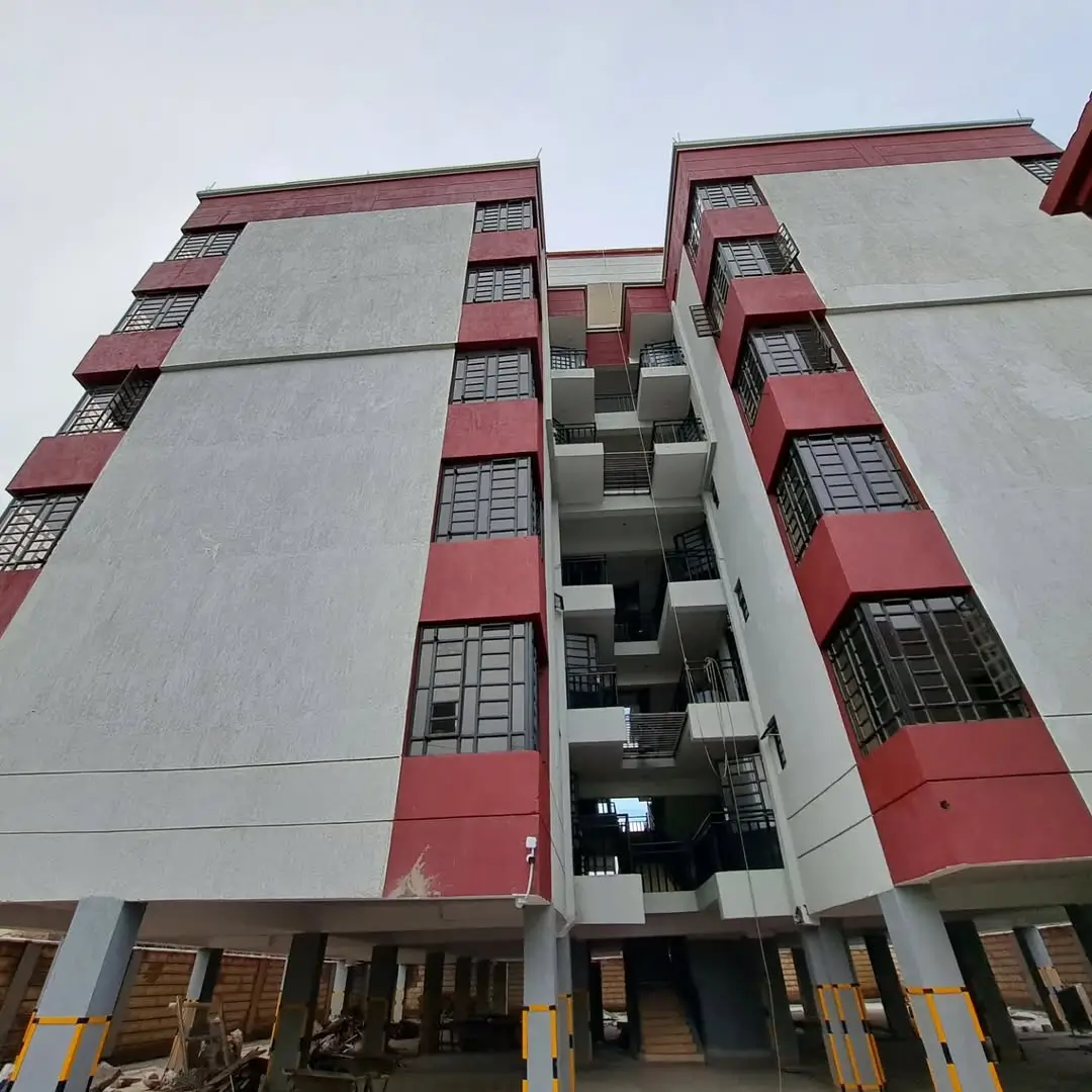 Multi-story residential building with red and white facade