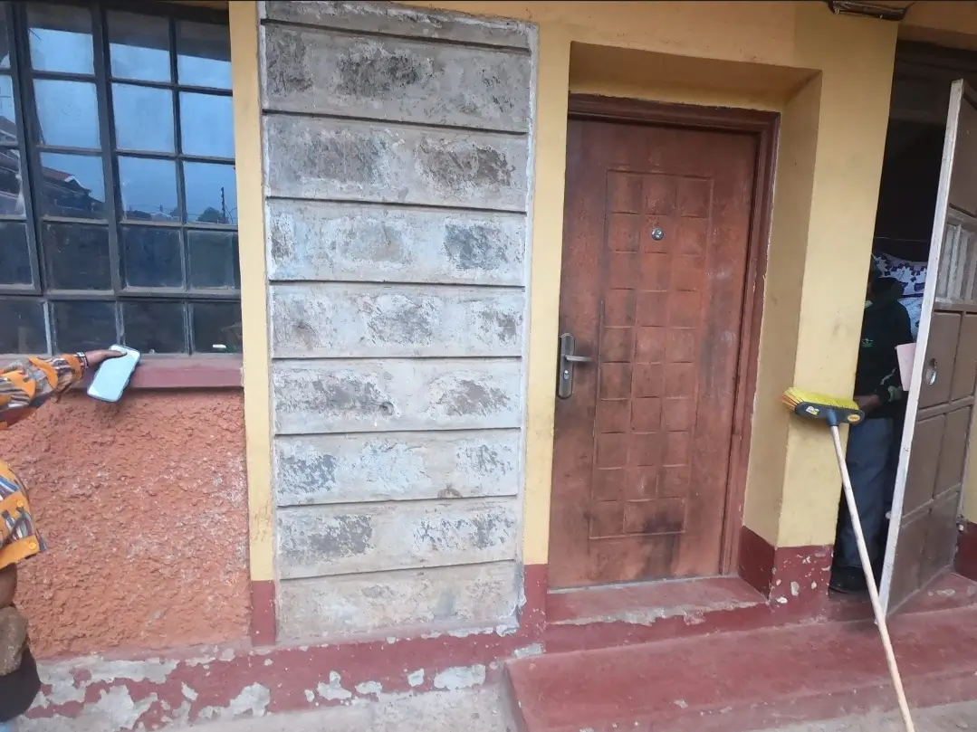 Building entrance with red door and tiled flooring