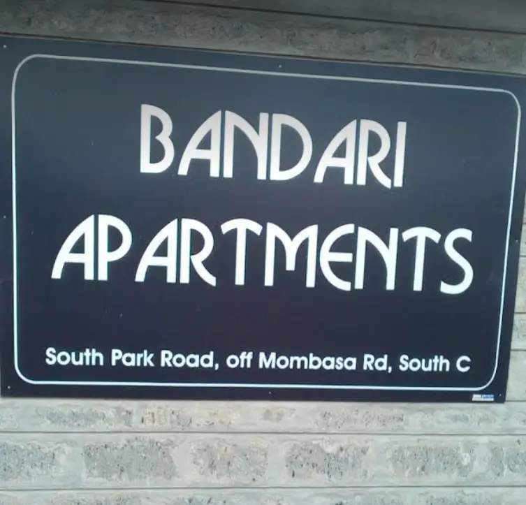 Bandari Apartments building signage on brick wall