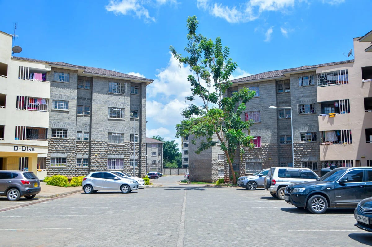 Multi-story apartment complex with central parking courtyard