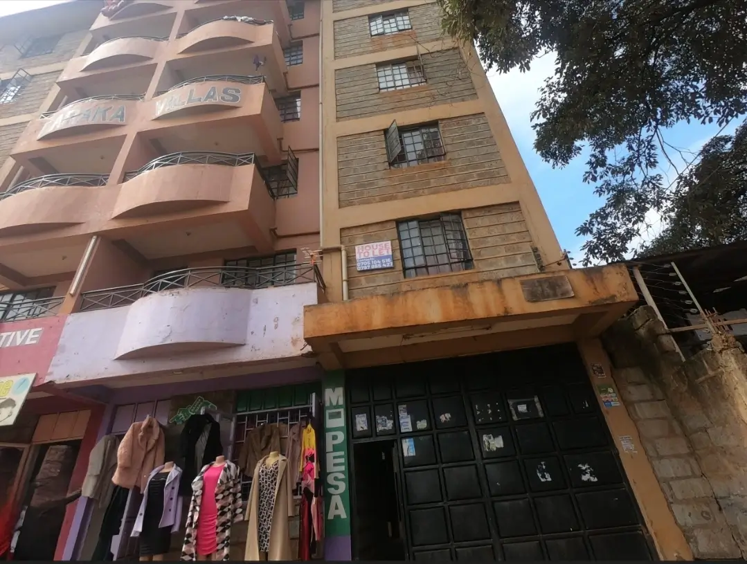Multi-story residential building facade with ground-floor retail