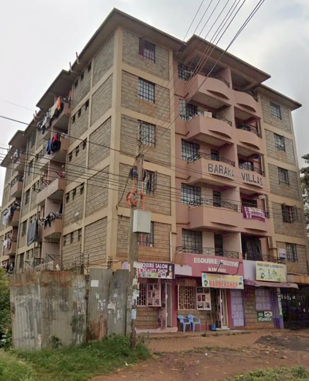 Multi-story residential building facade with ground-floor commercial units