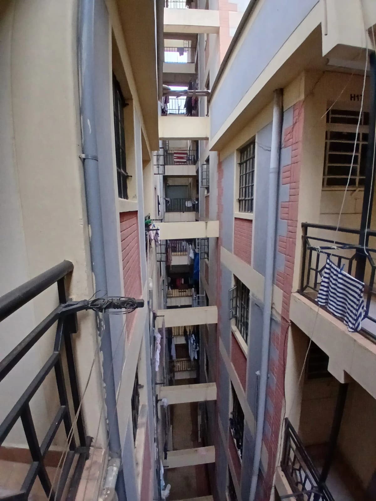 Multi-story internal courtyard with stairwell and railings
