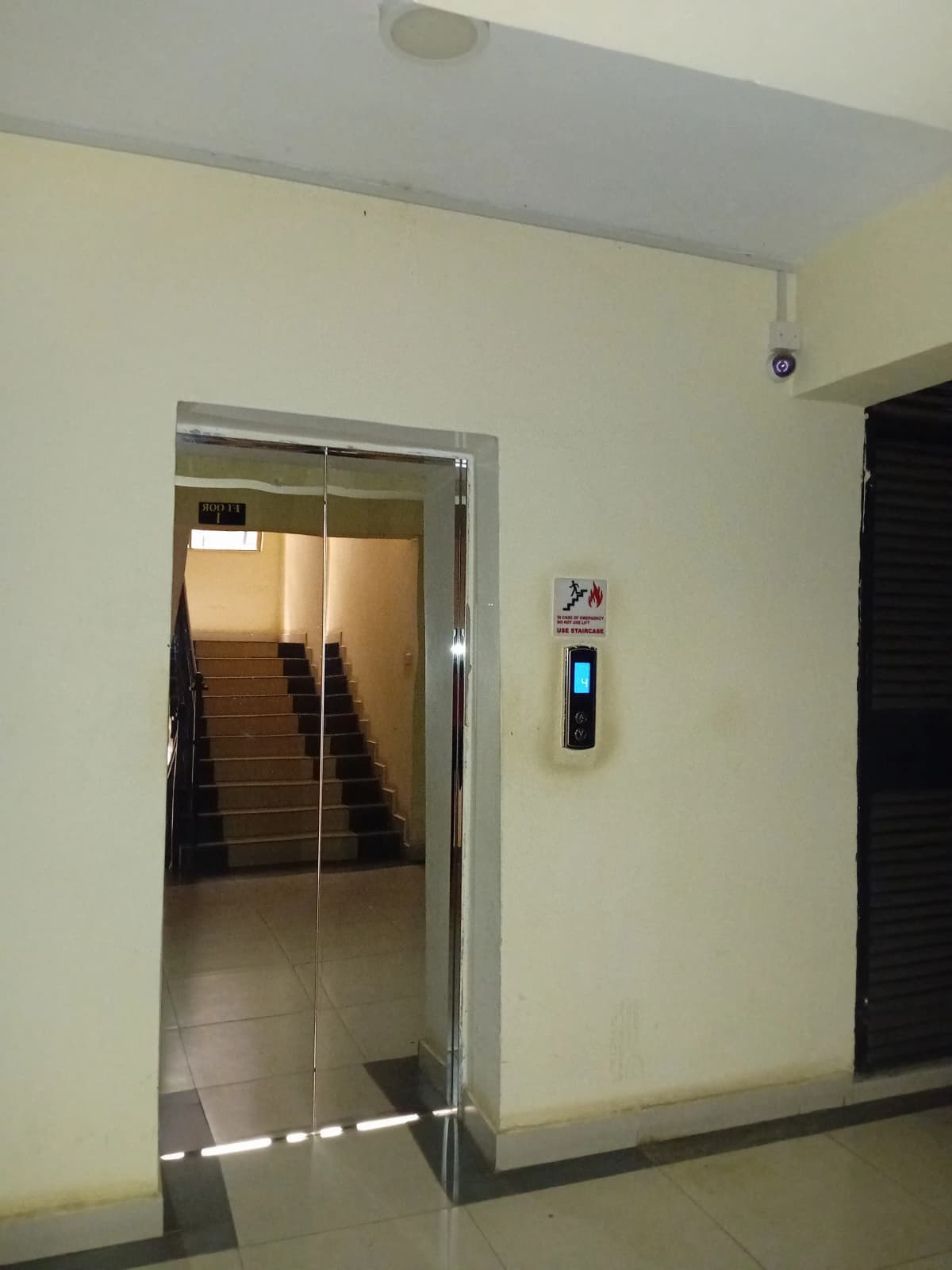 Building lobby with elevator and staircase access