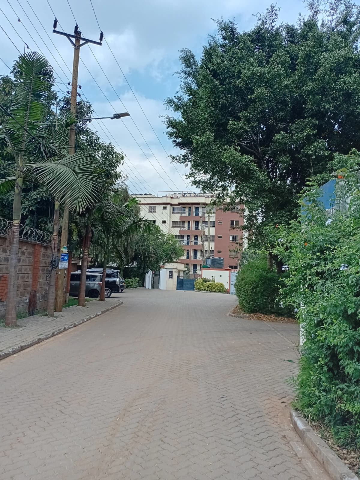 Compound entrance with paved driveway and apartment buildings