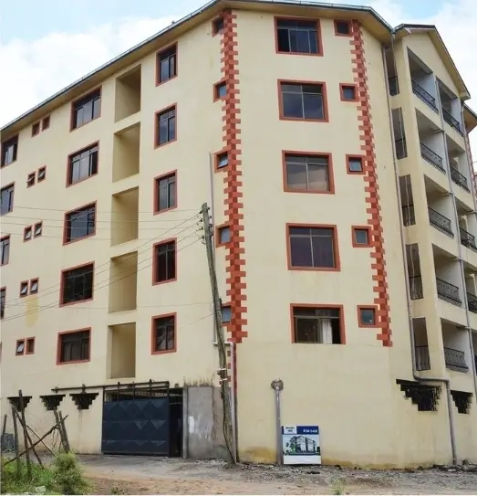 Multi-story residential building facade with red brick detailing