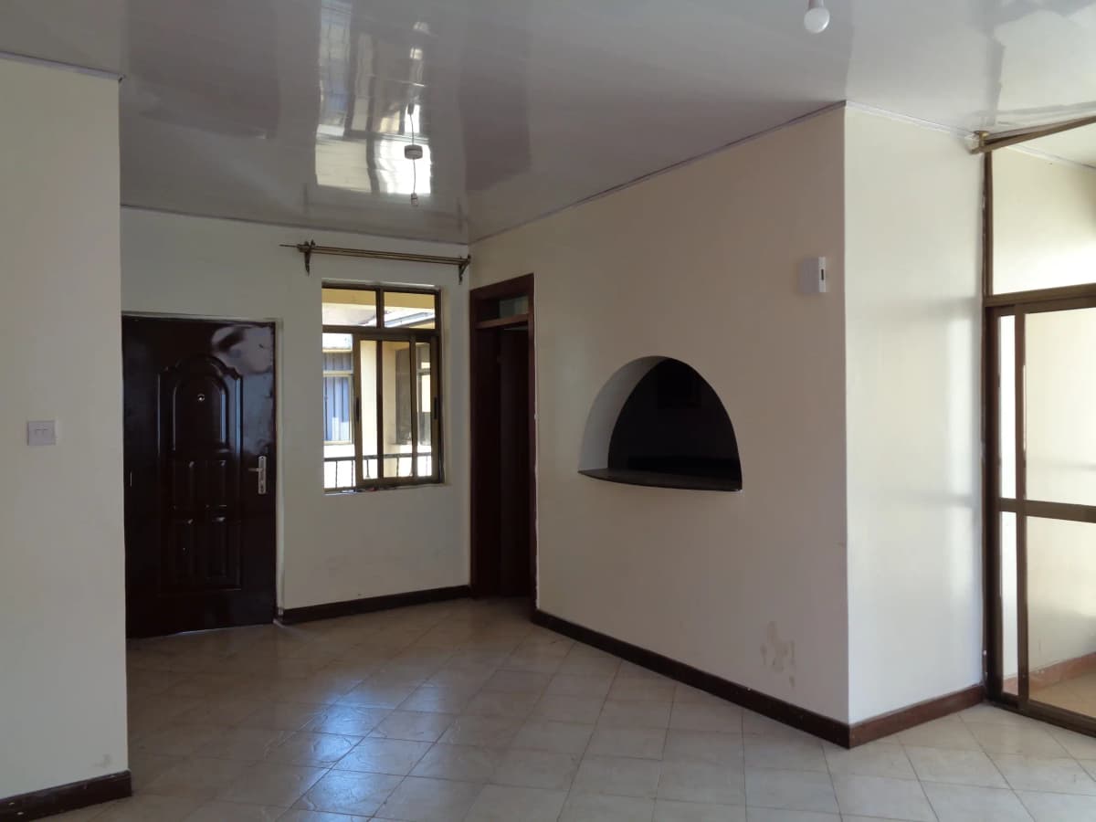 Spacious entrance lobby with tiled floor and dark wooden doors