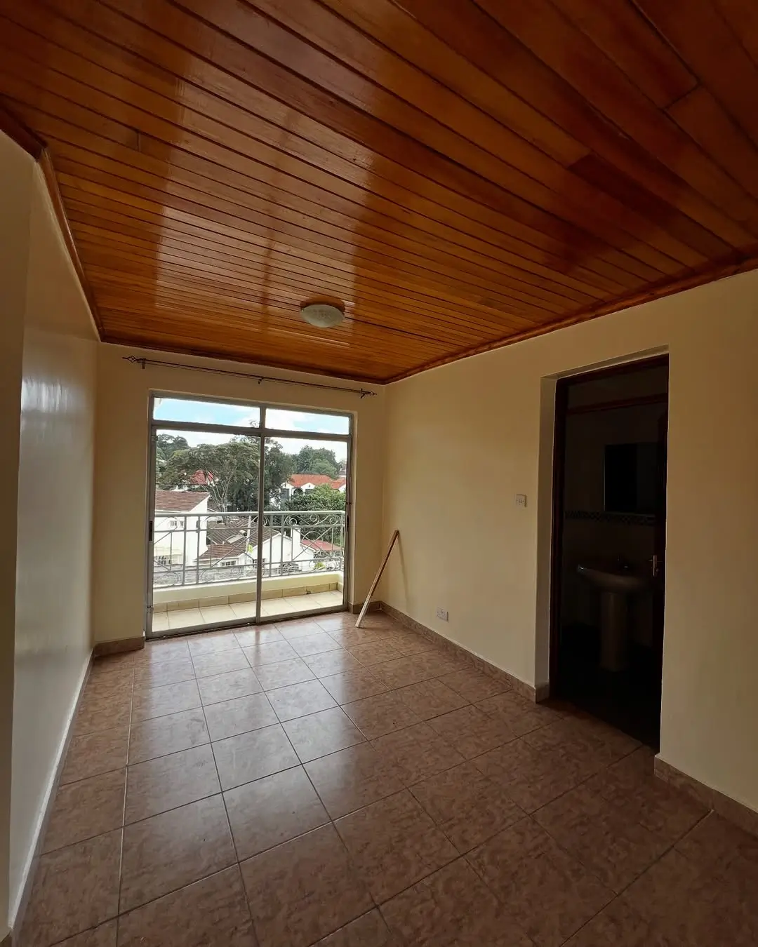 Spacious balcony with wooden ceiling and scenic compound views