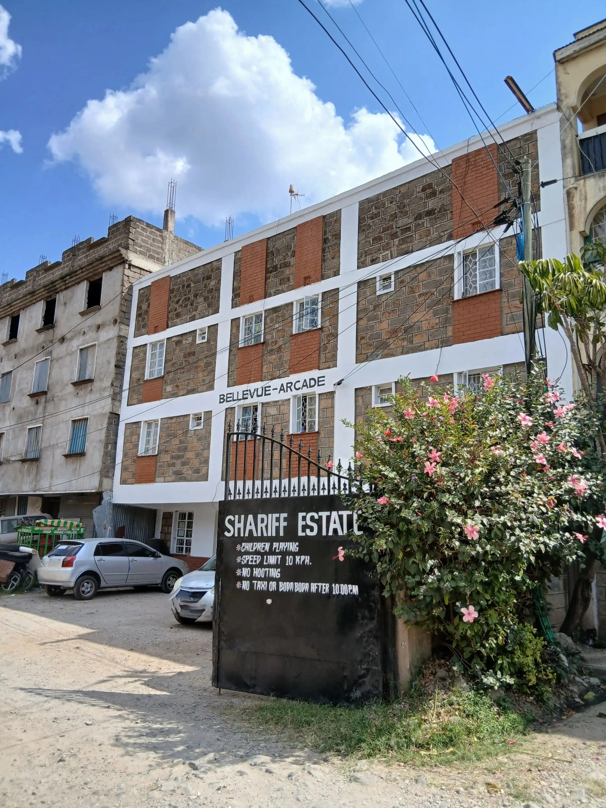 Multi-story residential building facade with mixed brick and stone