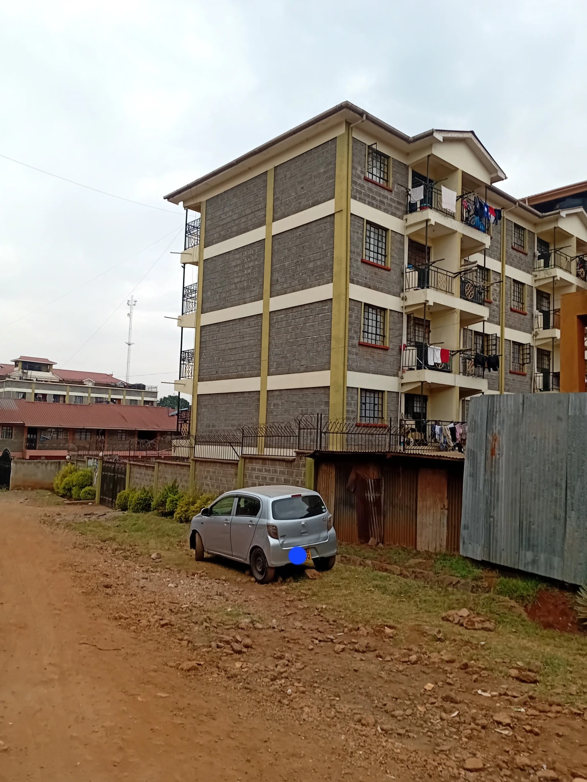 Multi-story residential building with stone facade and balconies