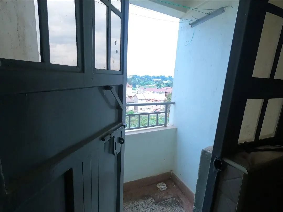 Compact balcony with city view and black railing