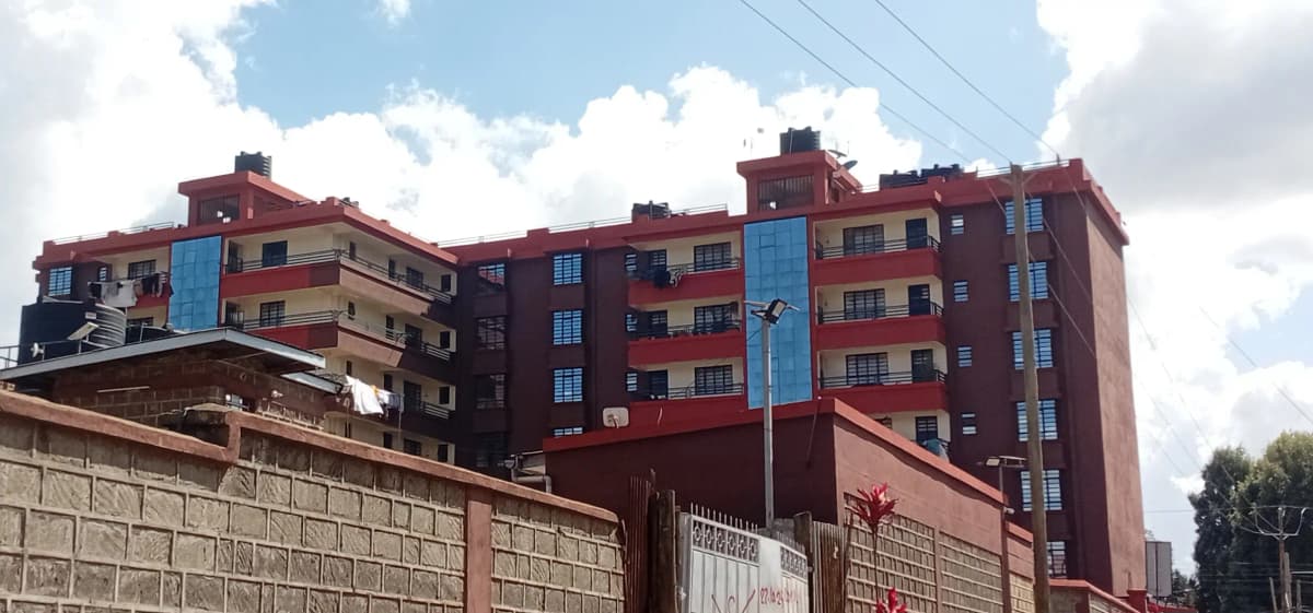 Multi-story residential building with red and blue facade