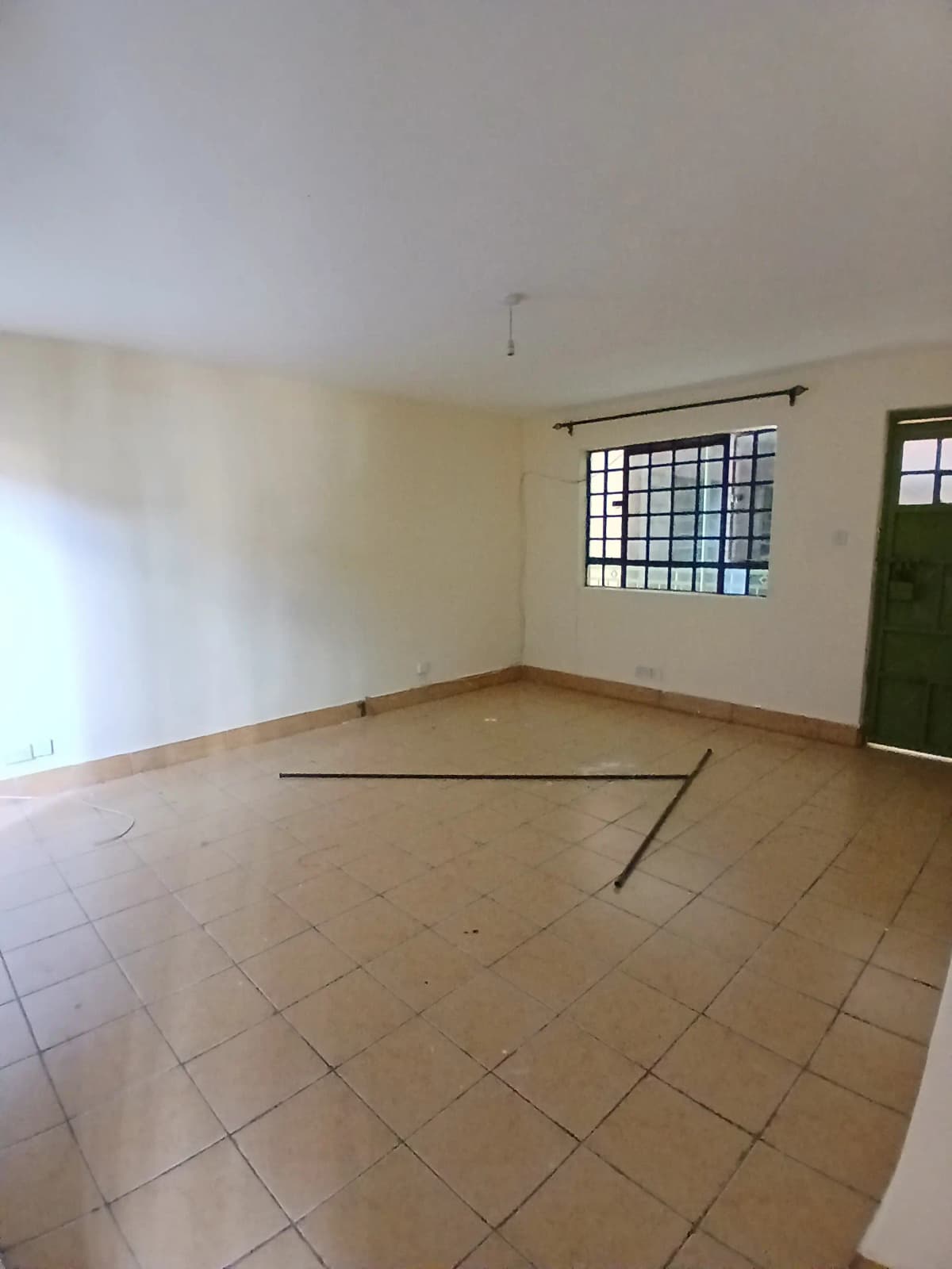 Spacious empty living room with terracotta tile flooring