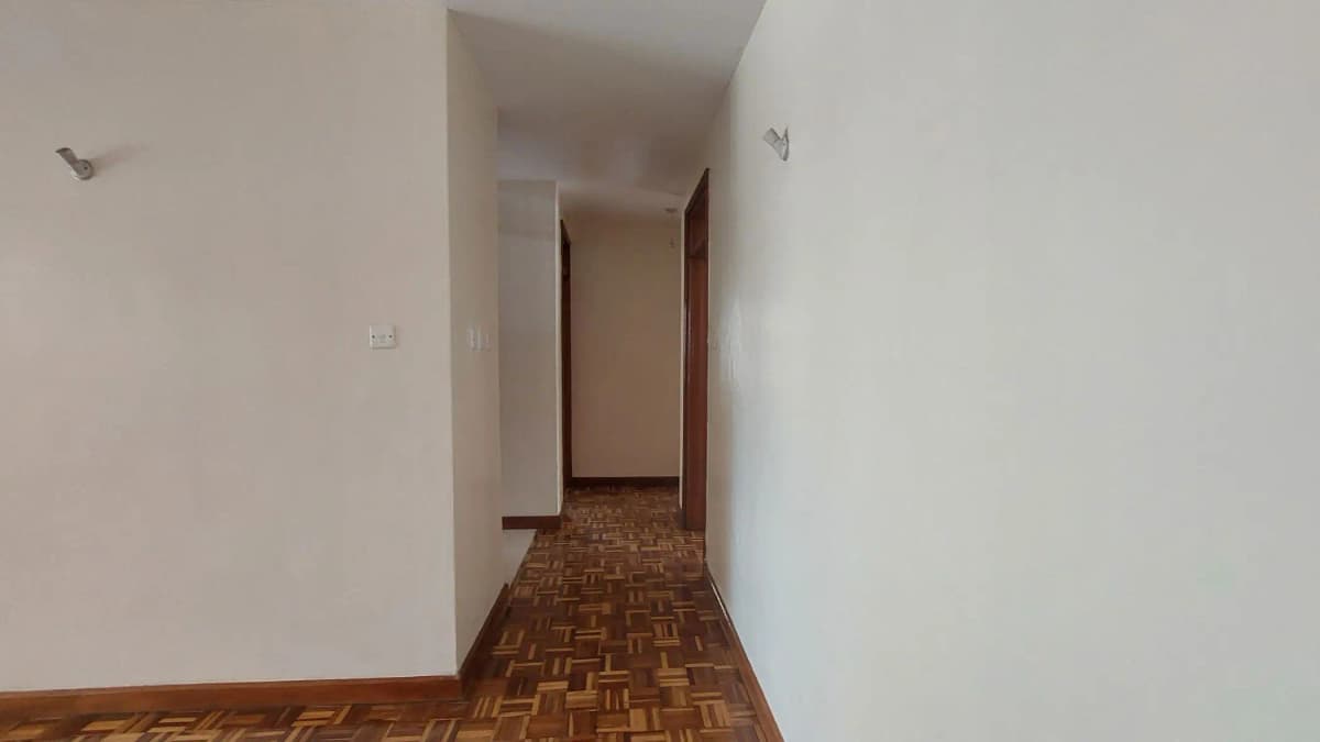 Long narrow hallway with herringbone parquet flooring
