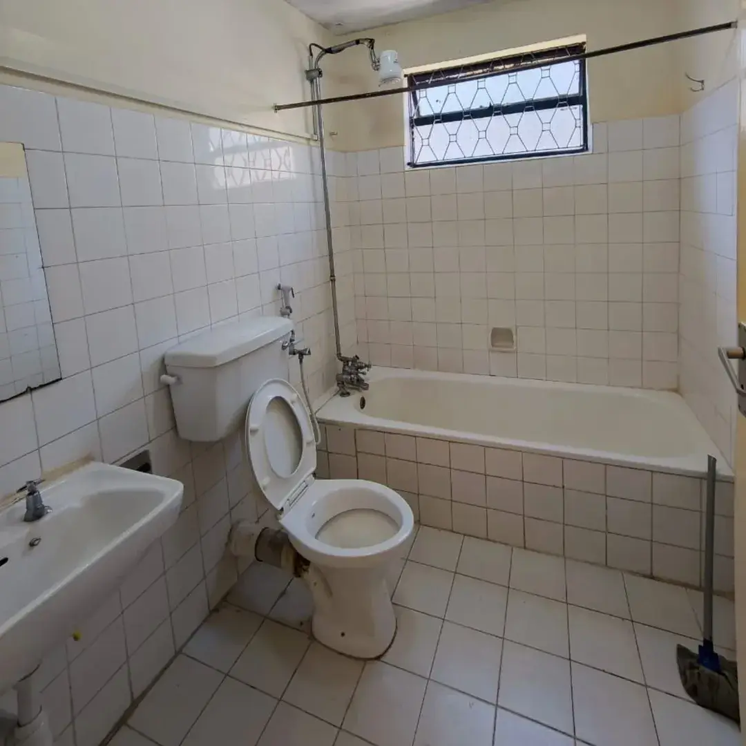 Basic bathroom with toilet, sink, bathtub and window