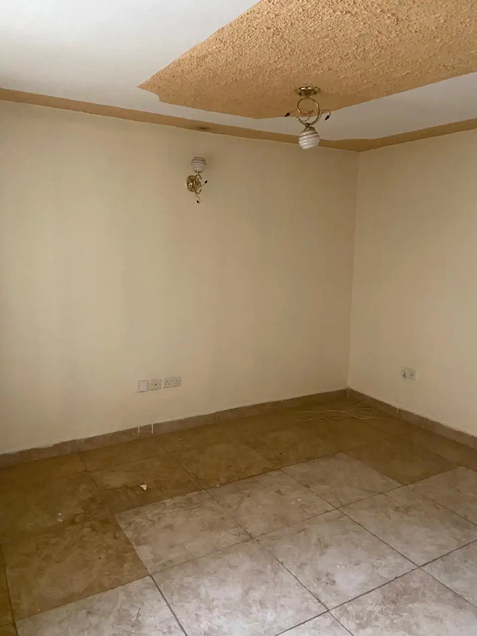 Empty living room with ceiling fan and textured ceiling