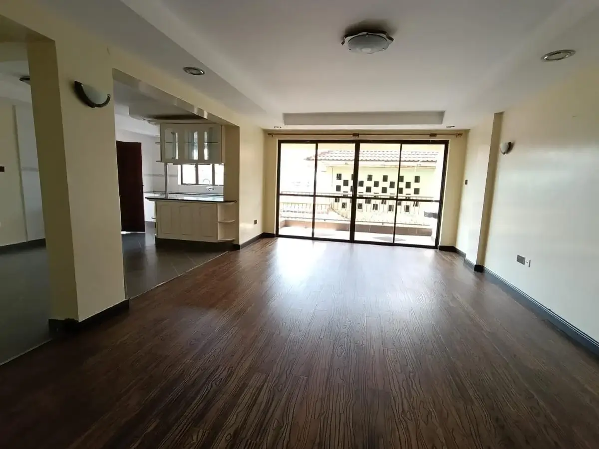 Spacious open-plan living area with dark wood flooring
