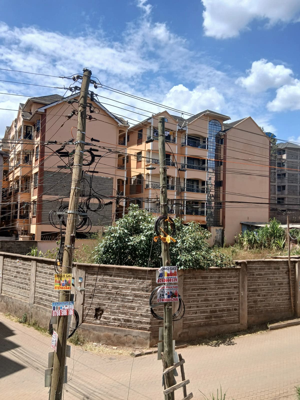 Multi-story residential building with perimeter wall and gate