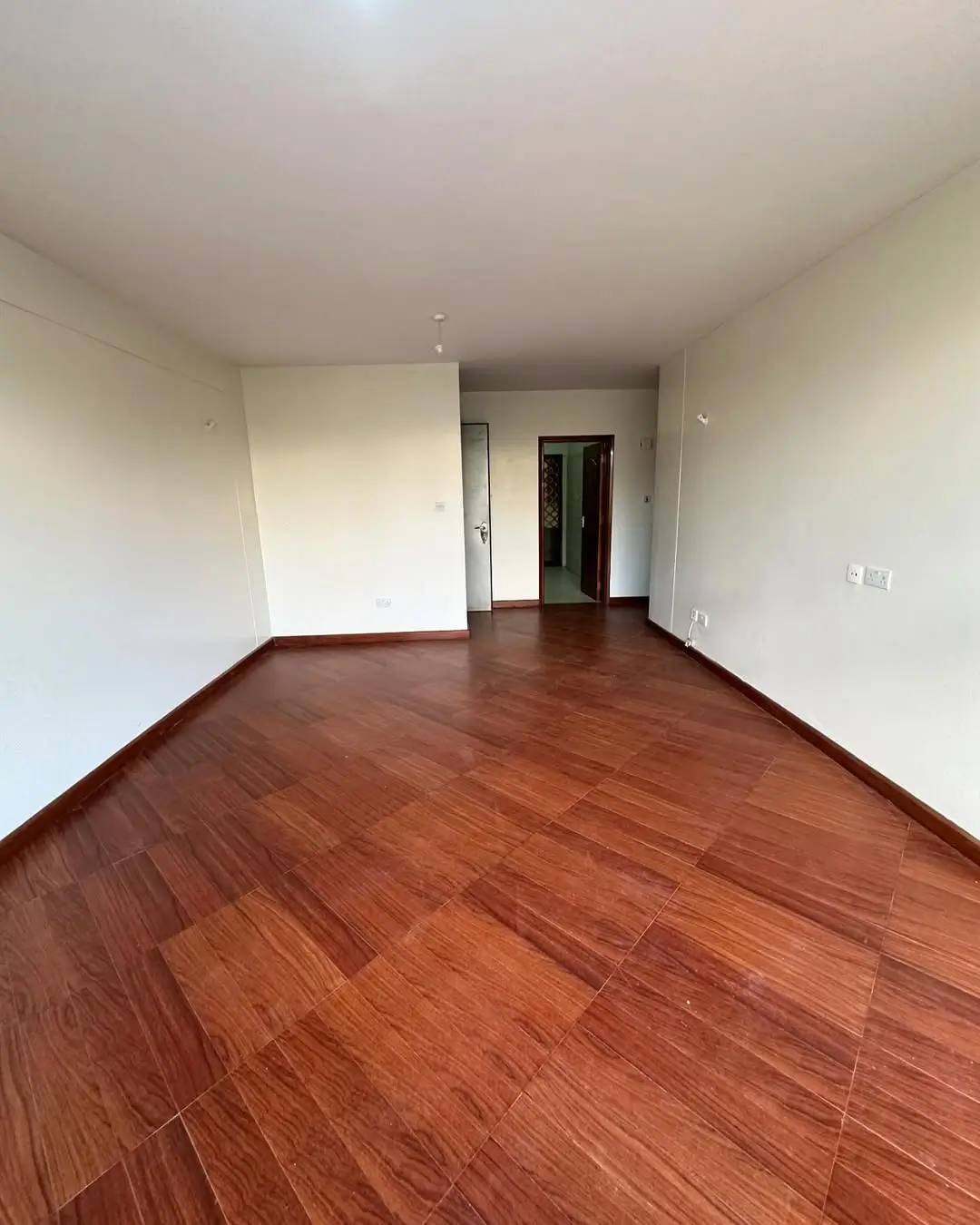 Spacious living room with polished wooden flooring