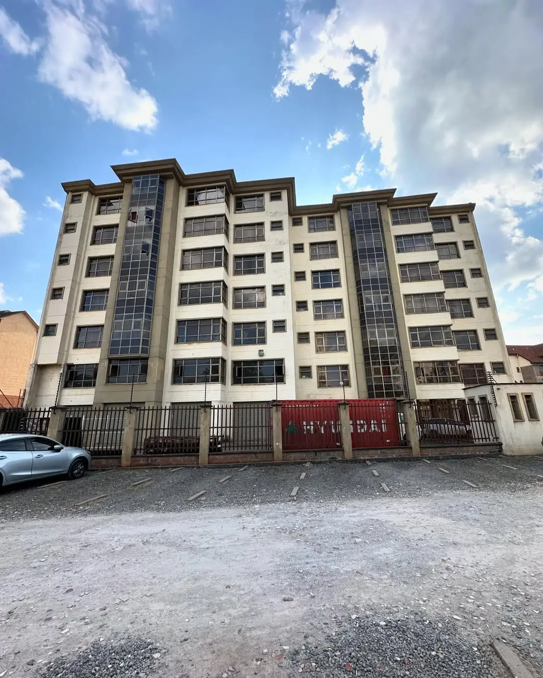 Modern residential apartment building with secure gate entrance
