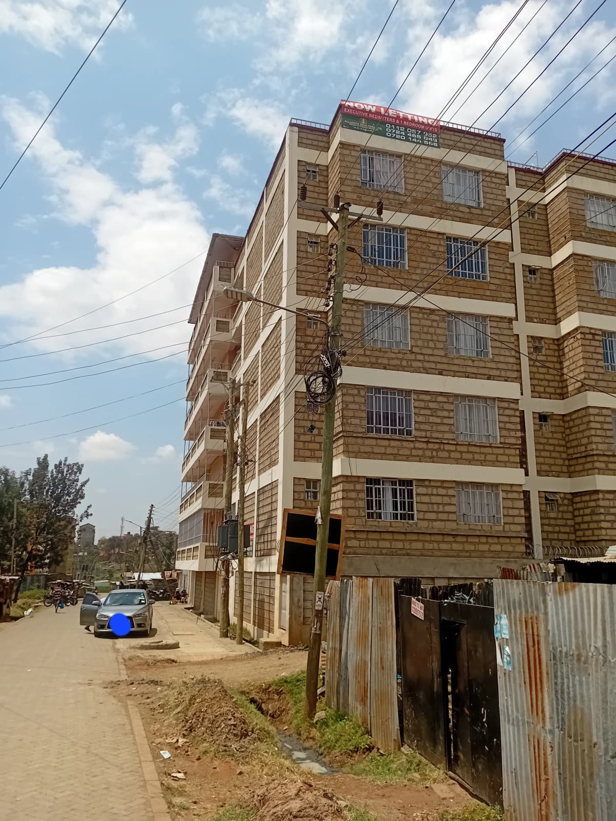 Multi-story residential building facade with street view