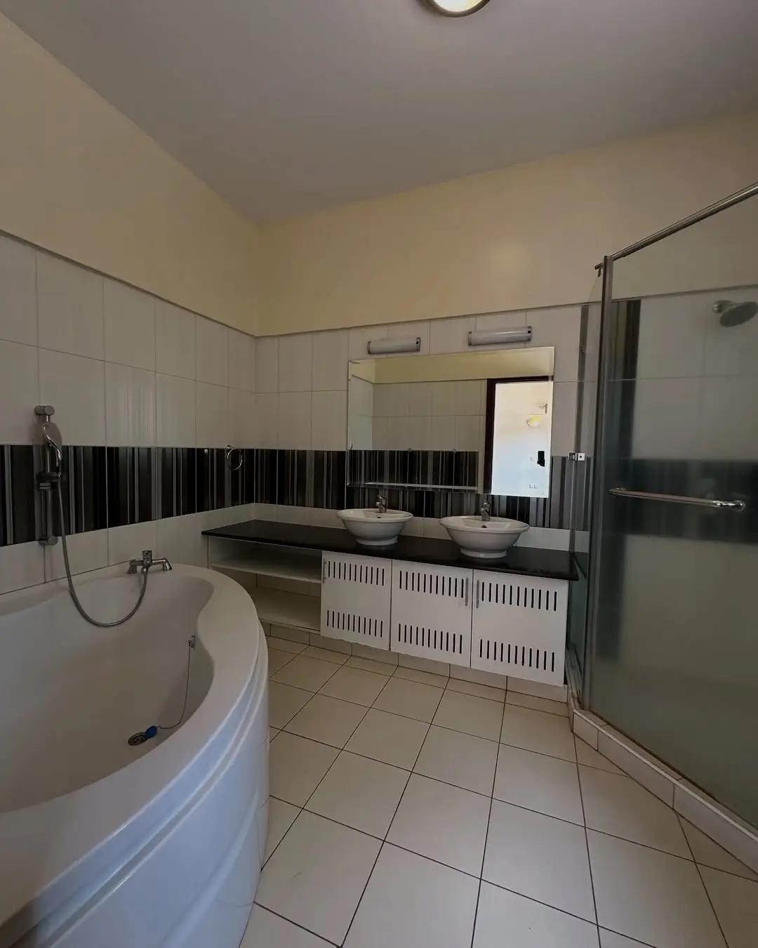 Spacious bathroom with soaking tub and dual vanity