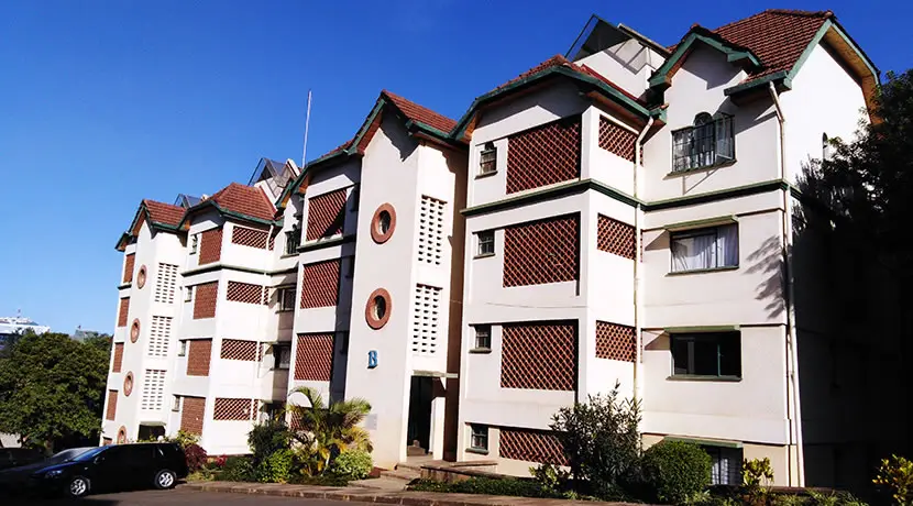 Multi-story residential apartment building with brick and white facade