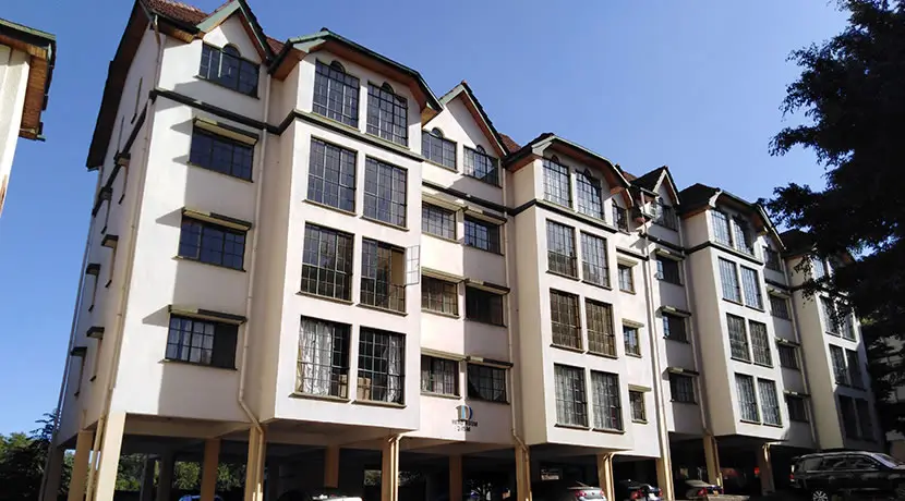 Multi-story residential building with cream and dark timber facade