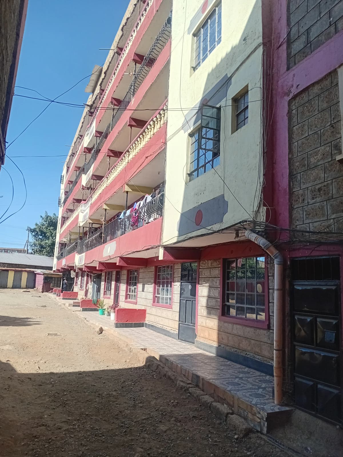 Multi-story residential building facade with ground floor retail
