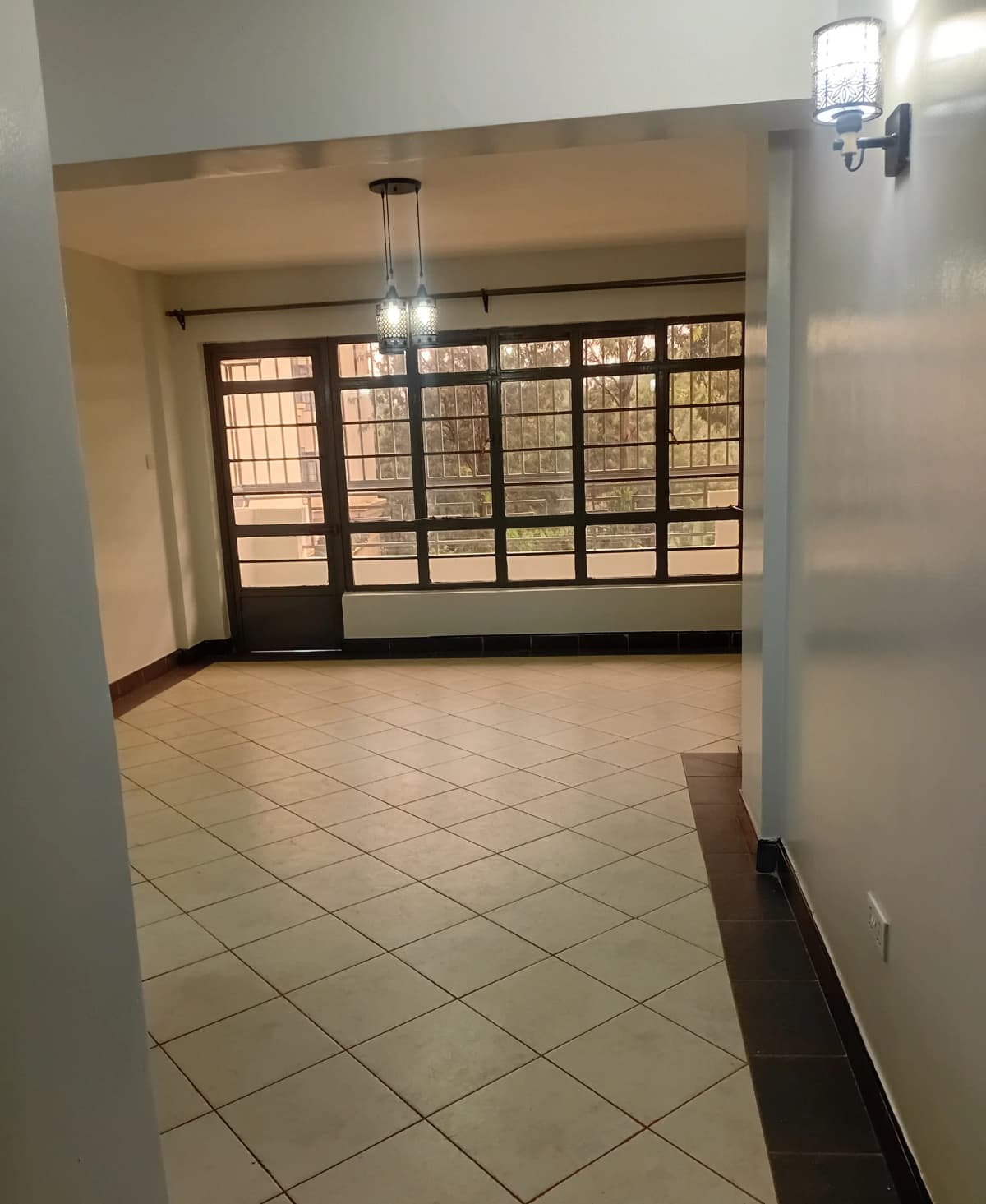 Building entrance lobby with large storefront windows and tile flooring